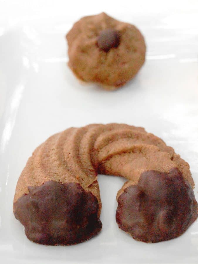 Chocolate Spritz Cookies Recipe - How to Press Cookies [+Chocolate Dipped variety] from scratch pastry with cocoa powder enriched and pressed with a piping bag or cookie press. Learn how to make chocolate spritz cookies easily! www.MasalaHerb.com #cookies #masalaherb #chocolate #christmas