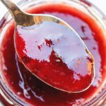 close up of plum jam in a spoon