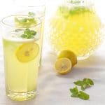 mint lemonade in a glass with lemon slices