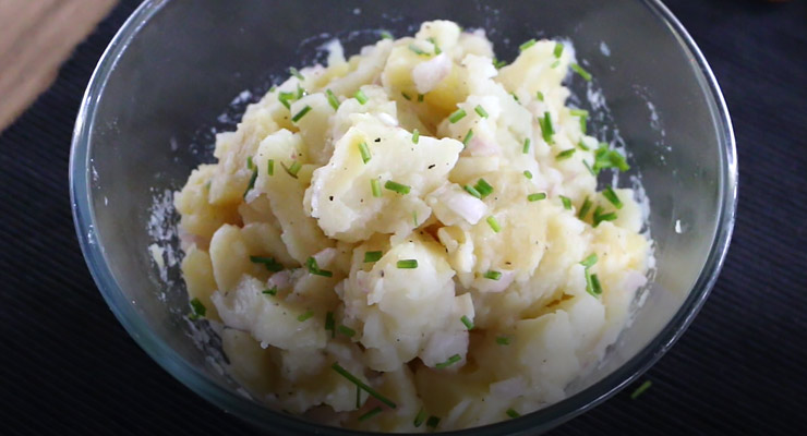 pour broth over potatoes and top with chives