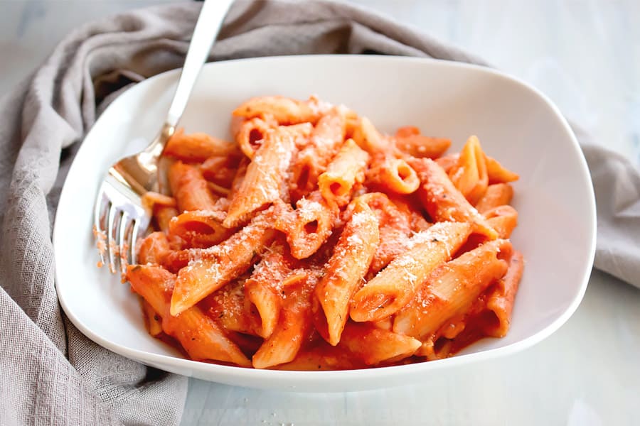 pasta with vodka tomato sauce in a shallow plate