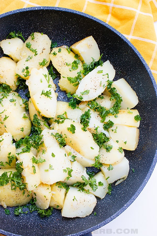 cooked skillet potatoes with parsley bird view