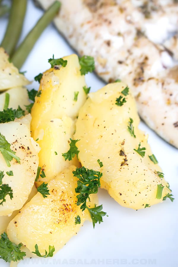 potatoes with butter and fresh parsley close up