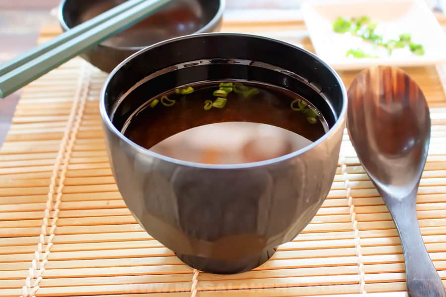 japanese miso soup in bowl with garnish