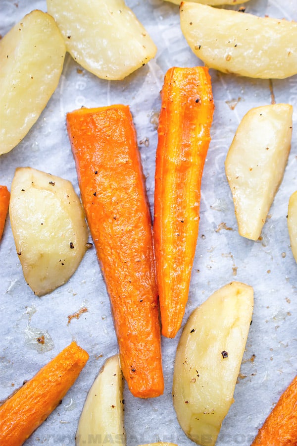roasting carrots and potato on sheet pan close up