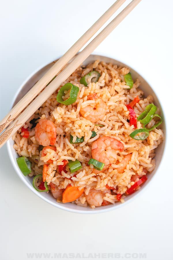 bird's eyes view of shrimp fried rice in a bowl with chopsticks