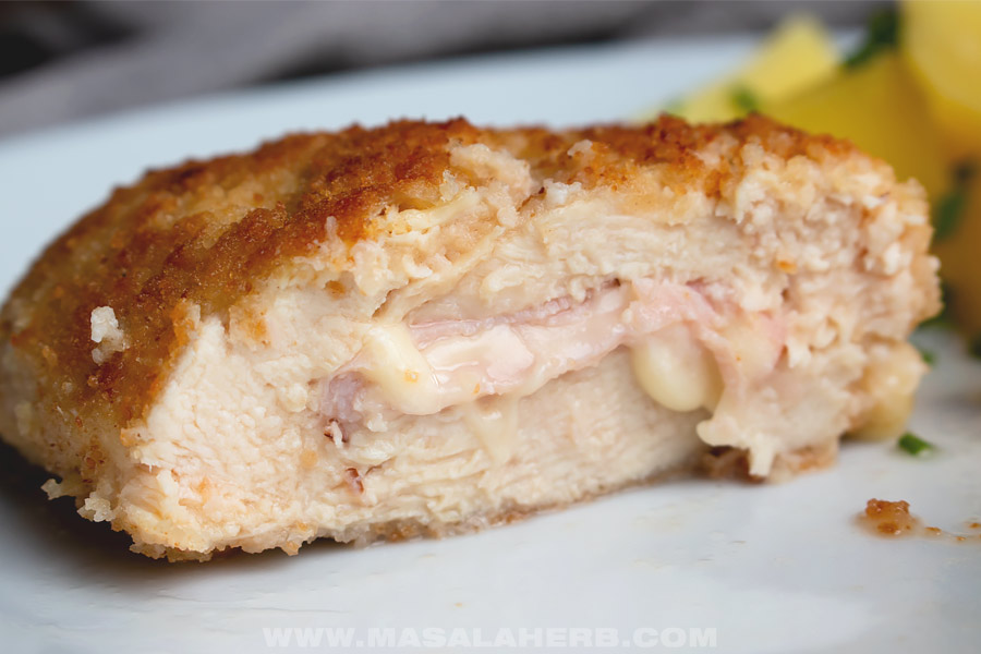 cordon bleu prepared with chicken, stuffed with cheese and ham cut open