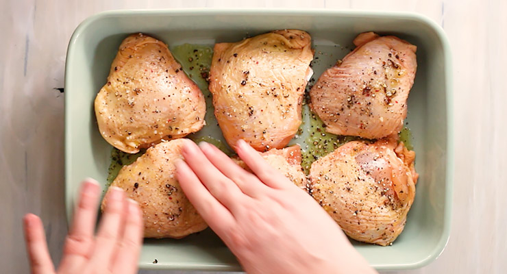 rub seasoning and oil into chicken thighs