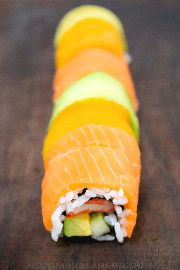 cut rainbow sushi roll into slices