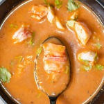 creamy intense lobster bisque in a spoon