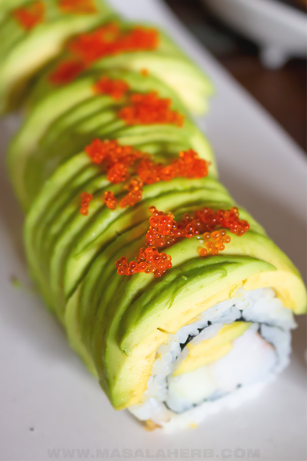 close up of green dragon roll and tobico