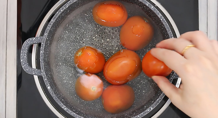 bring water to boil and place fresh tomatoes into water