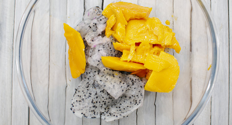 place mango and dragon fruit pulp into a bowl
