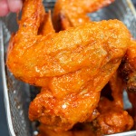 crispy chicken wings coated with buffalo sauce