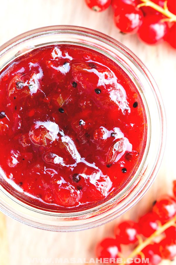 top down view of red currant chutney in a jar