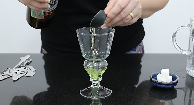 pour absinthe into glass