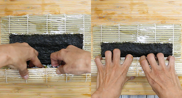 Roll and press down sushi roll gently with both hands to form a tight maki roll.