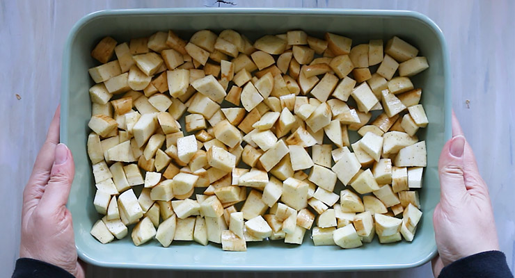 placing parsnip pieces into a baking dish