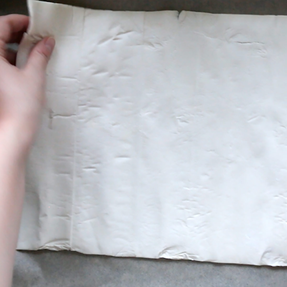 roll and place puff pastry sheet over parchment in a pan
