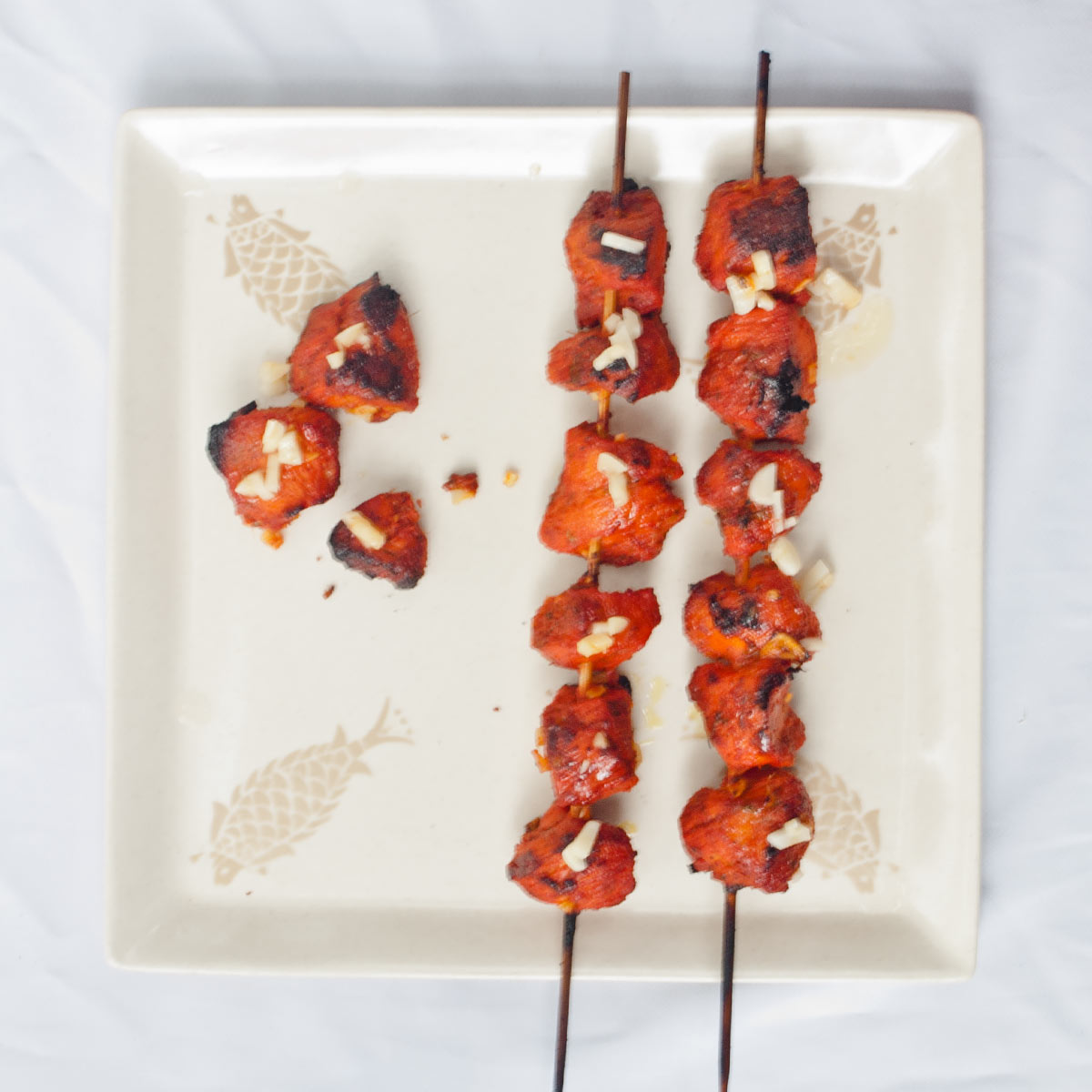 Chicken Tikka Kebab on skewers and on a plate
