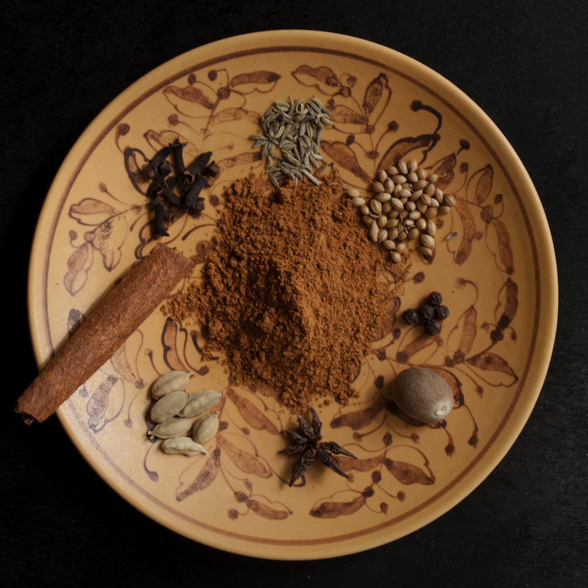 Lebkuchen Spice Mix with whole spices on a plate
