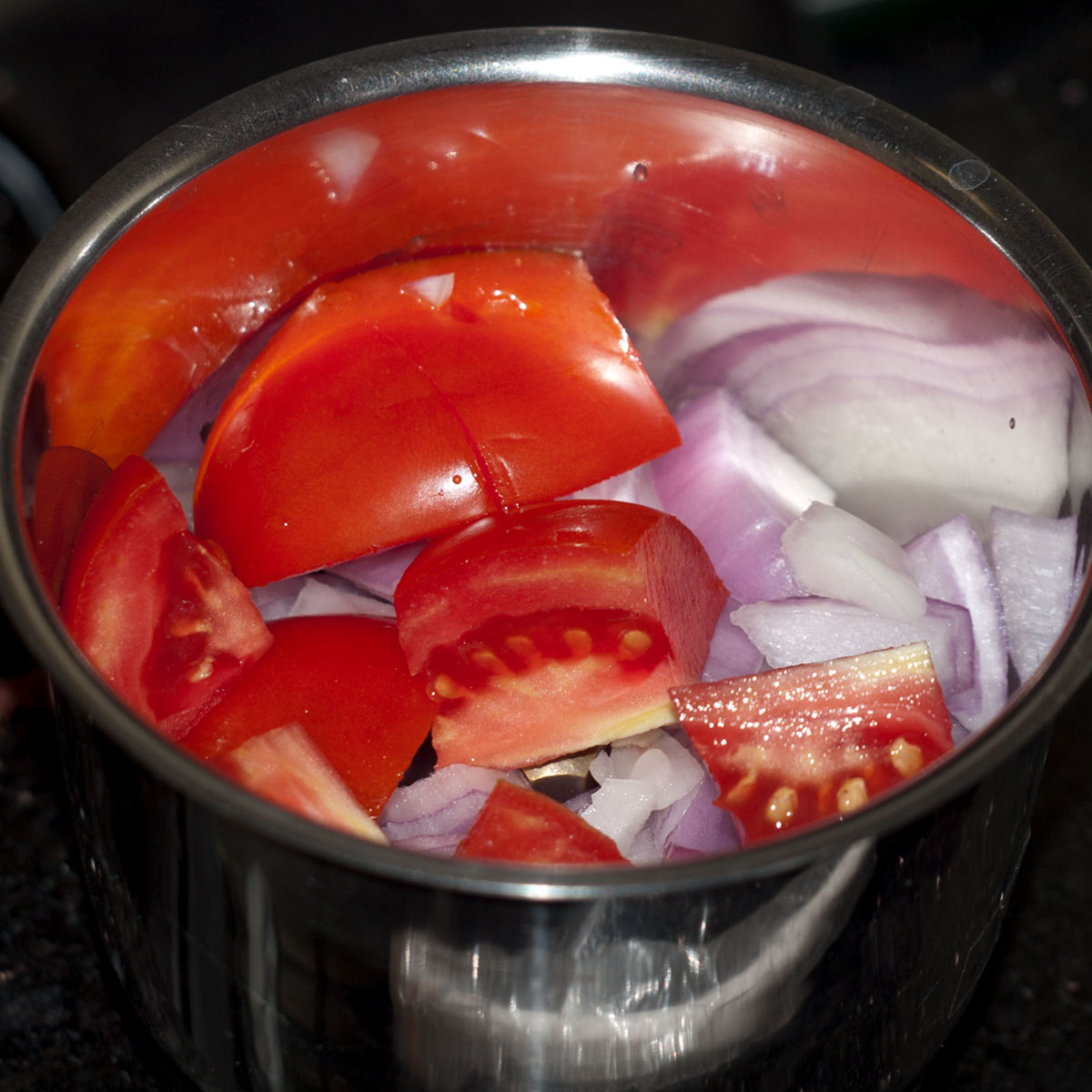 tomato and onion in a food processor jar
