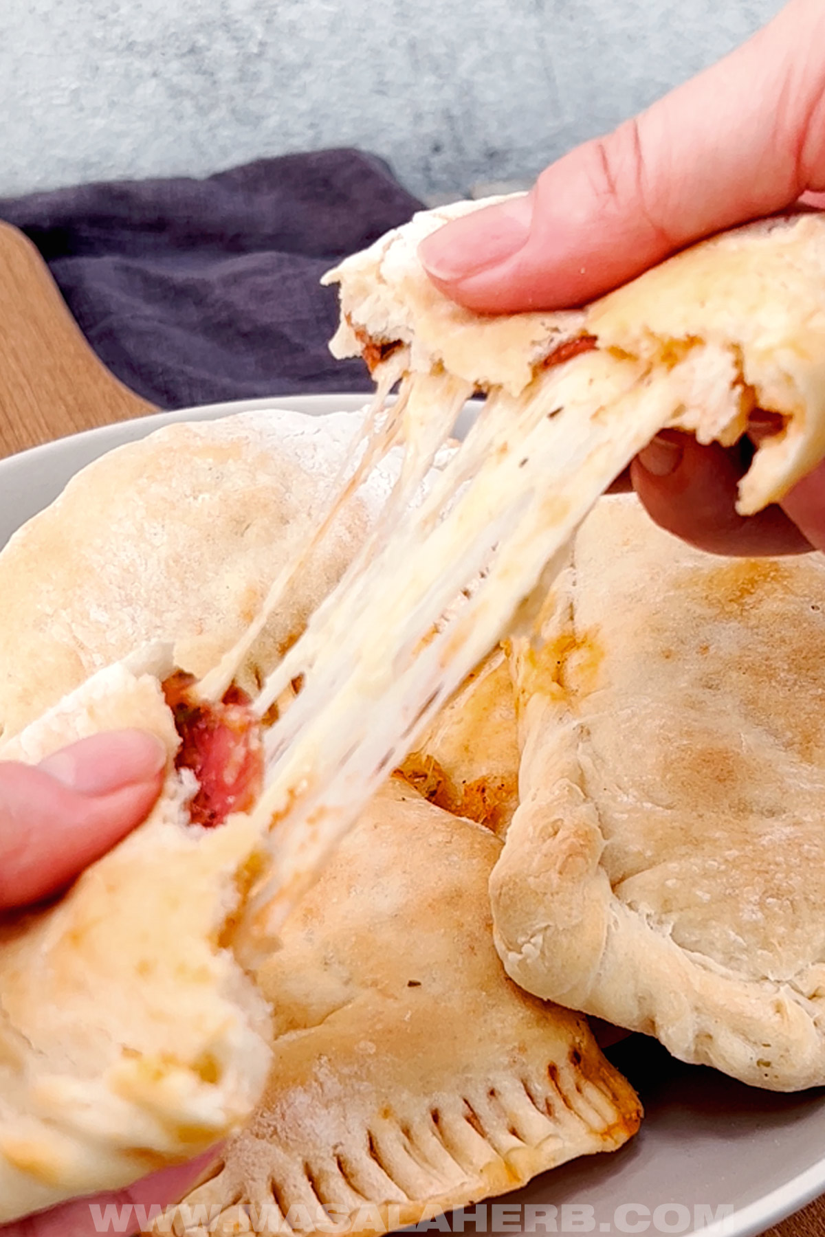 broken apart pizza pockets with stringy cheese