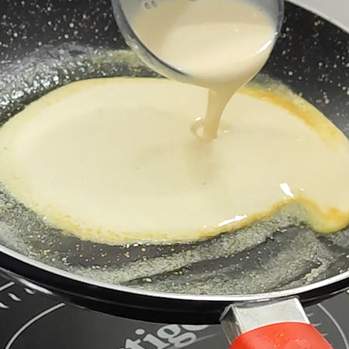 pour crepe batter into the hot skillet