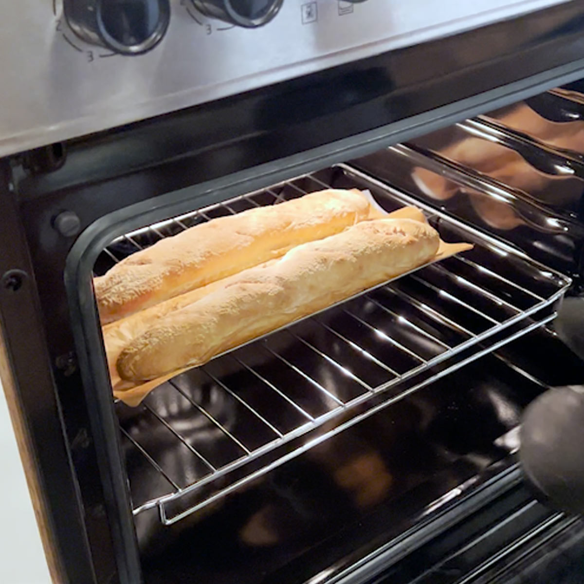 golden baked baguette ready to be taken out to cool
