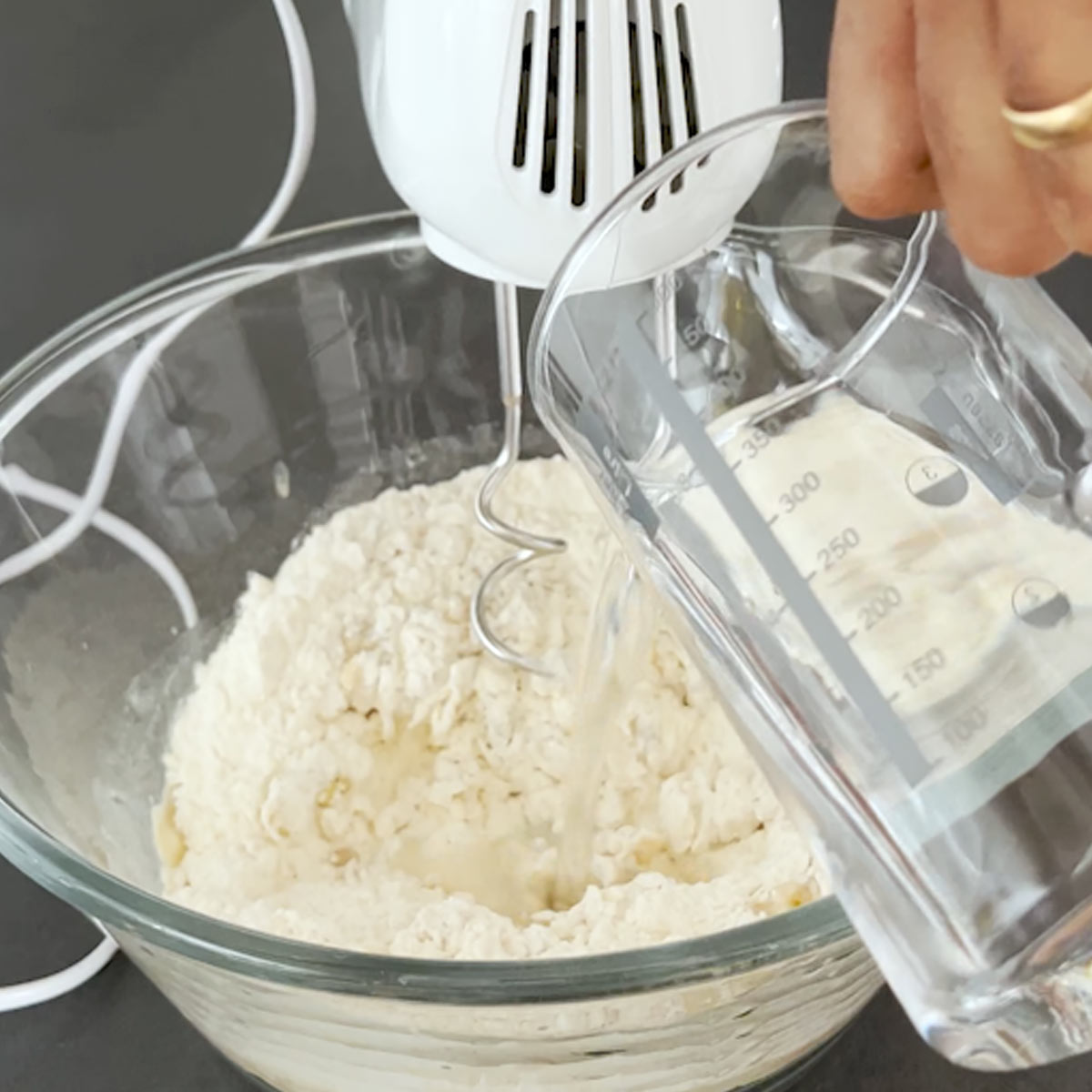 pour water to flour and other ingredients in the bowl