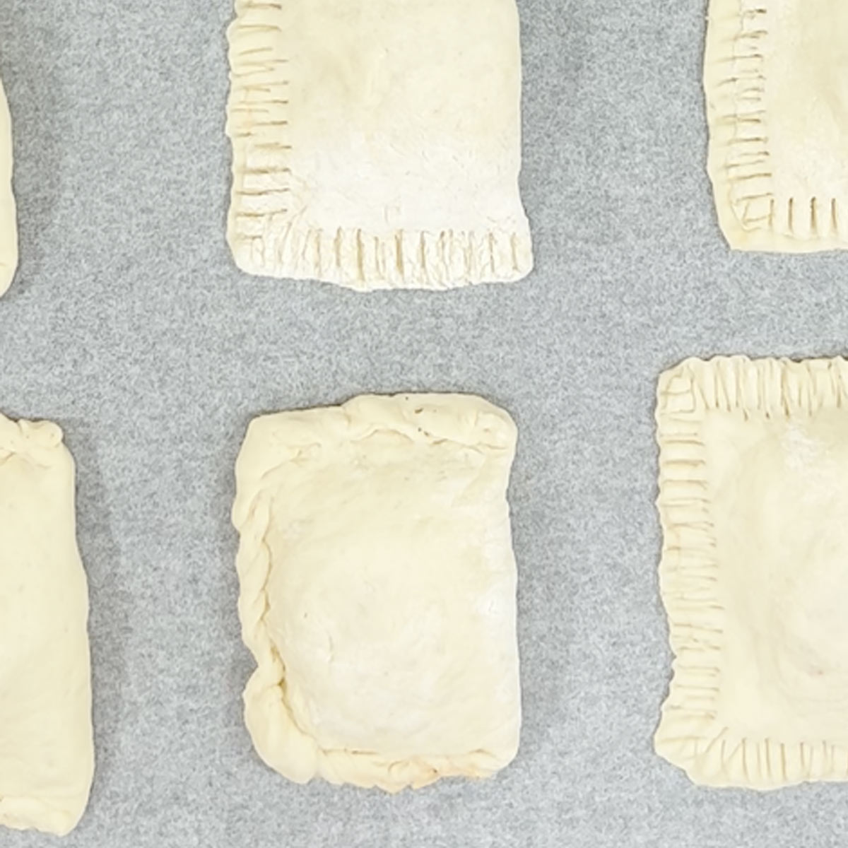 place pizza pockets on a baking pan lined with parchment paper