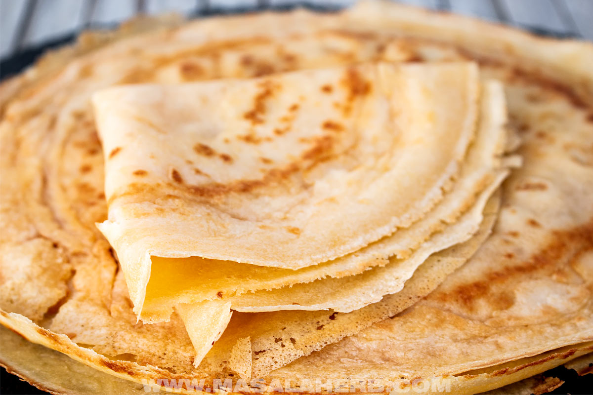 folded savory crepes over a stack of crepes