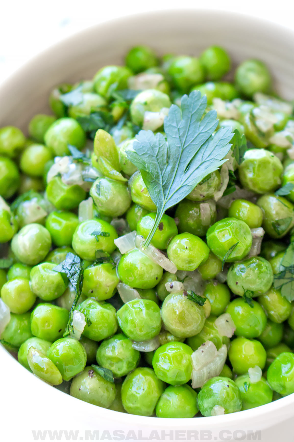 green peas in a bowl with parsley