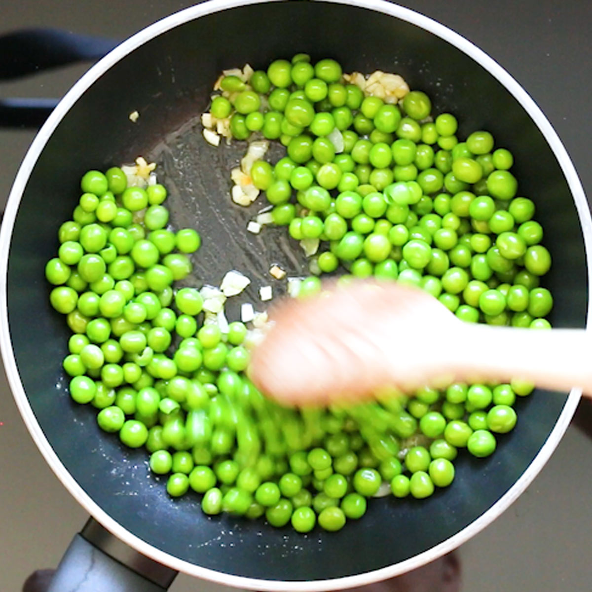 stir green peas to butter and olive oil