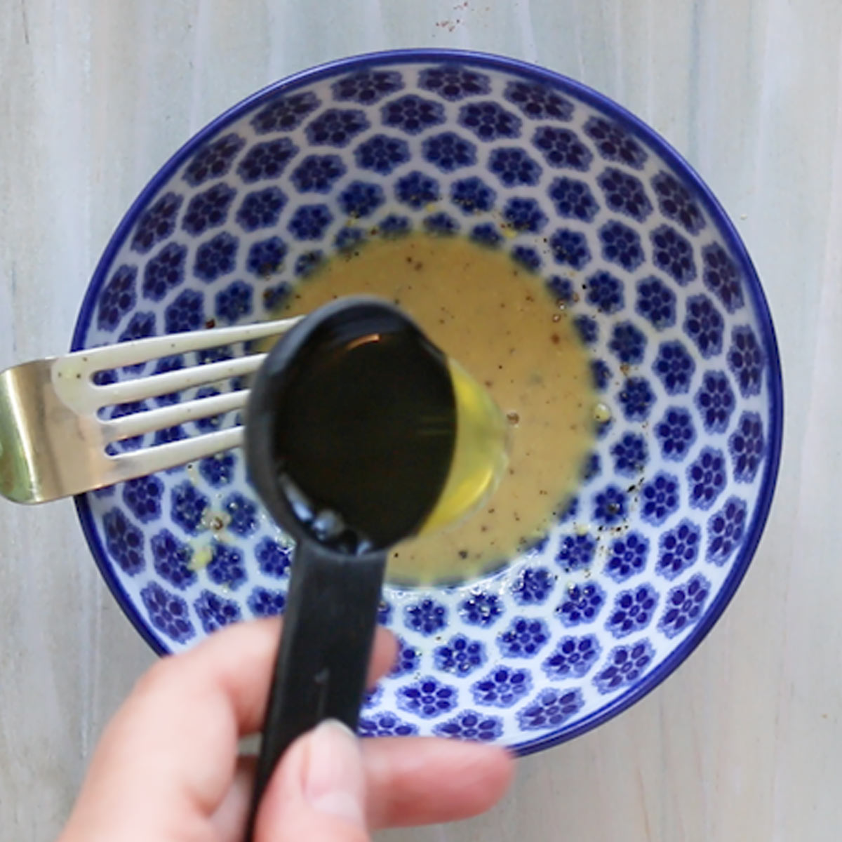 pour oil to vinaigrette ingredients