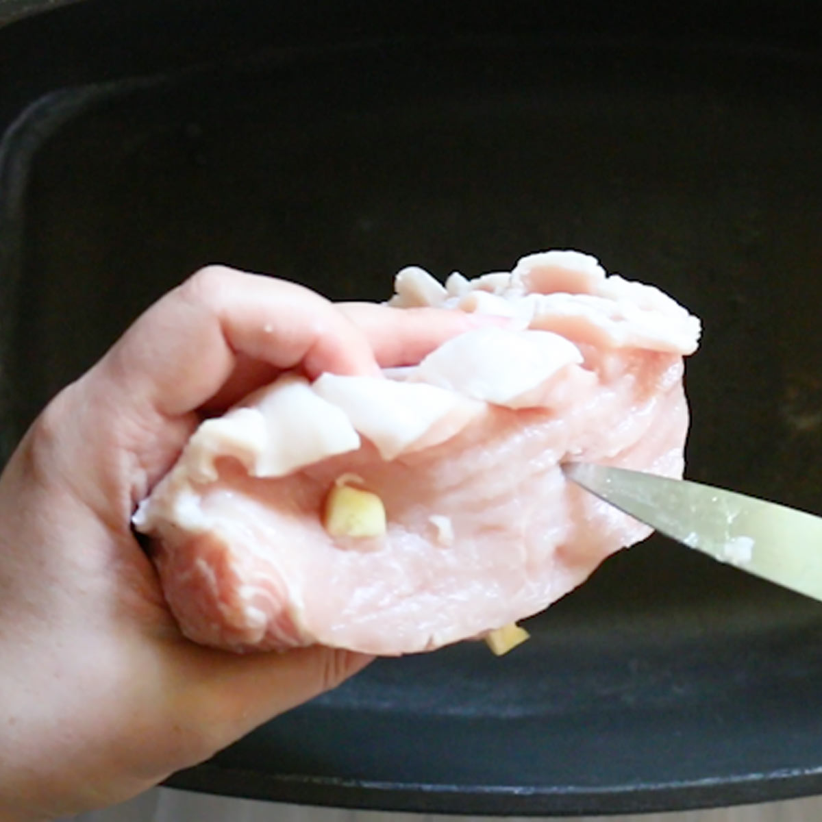 cut holes into the pork loin and stuff with garlic