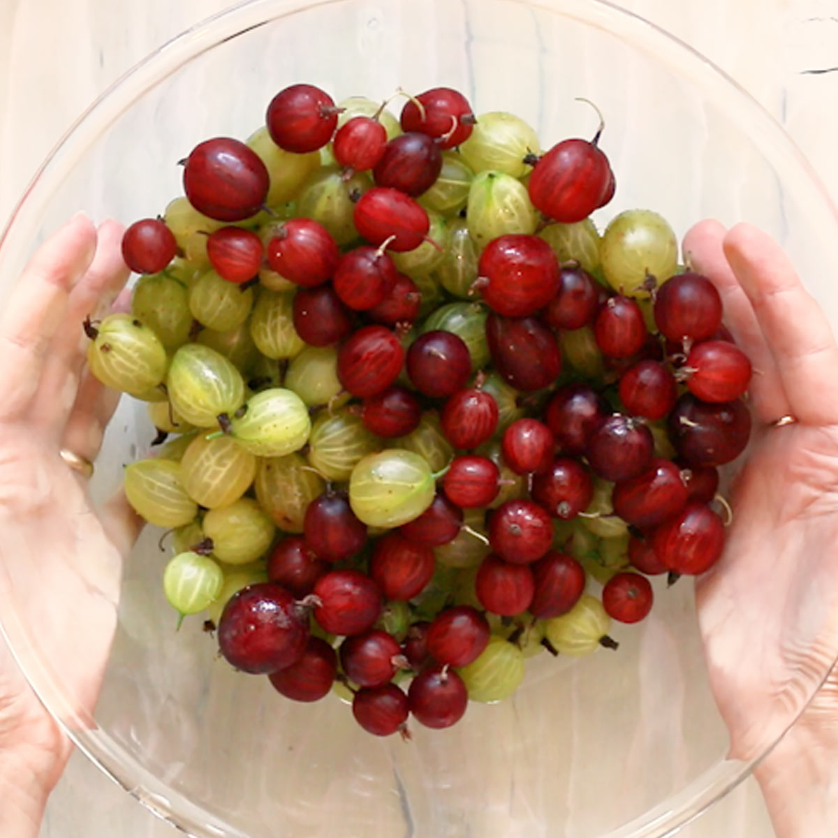 clean fresh red and green gooseberries in a bowl