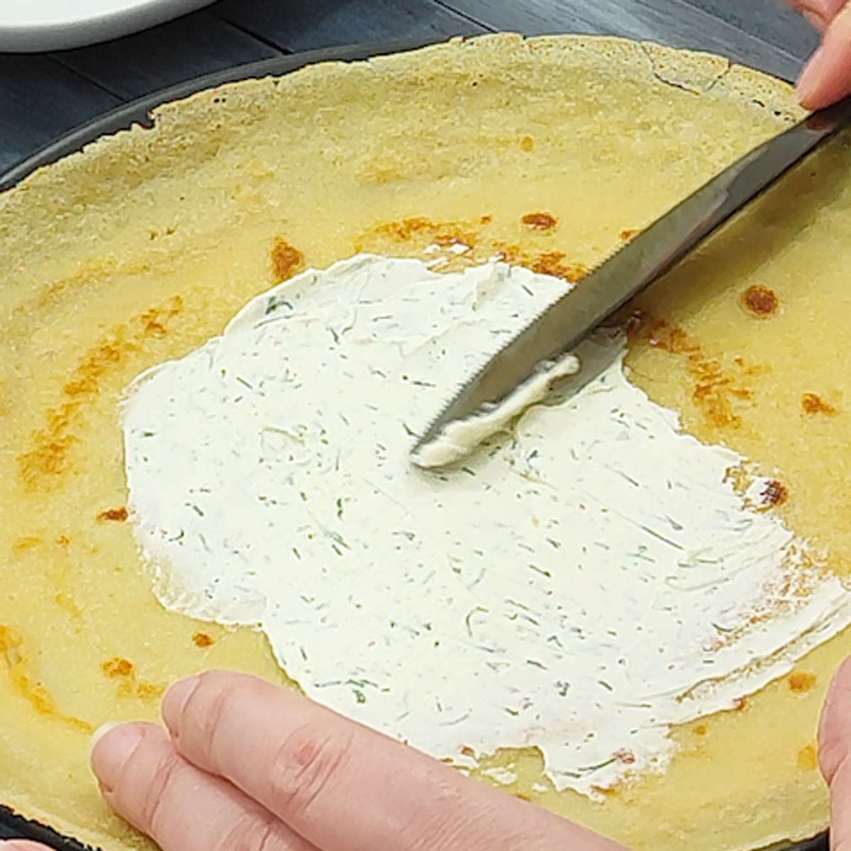 cream cheese filling spread over crepes