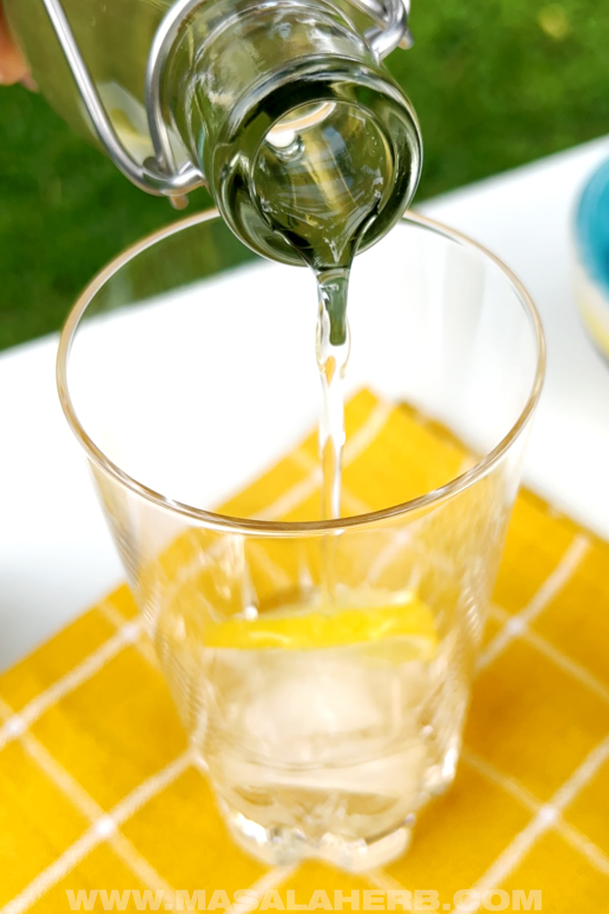 Pouring elderflower syrup into a glass