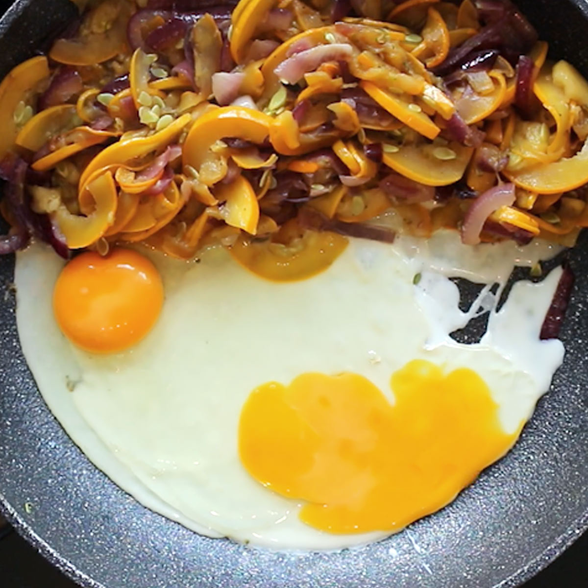 break eggs into skillet with zucchini