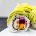 close up of avocado cucumber beet mango sushi