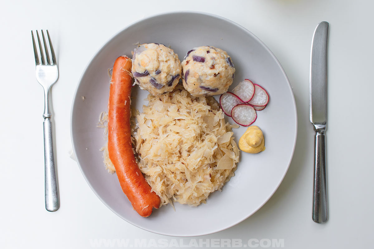 Cooked Sausage with Sauerkraut served up with German dumplings and mustard