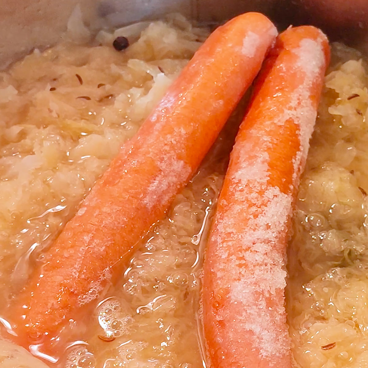 add sausages to sauerkraut over the stove top