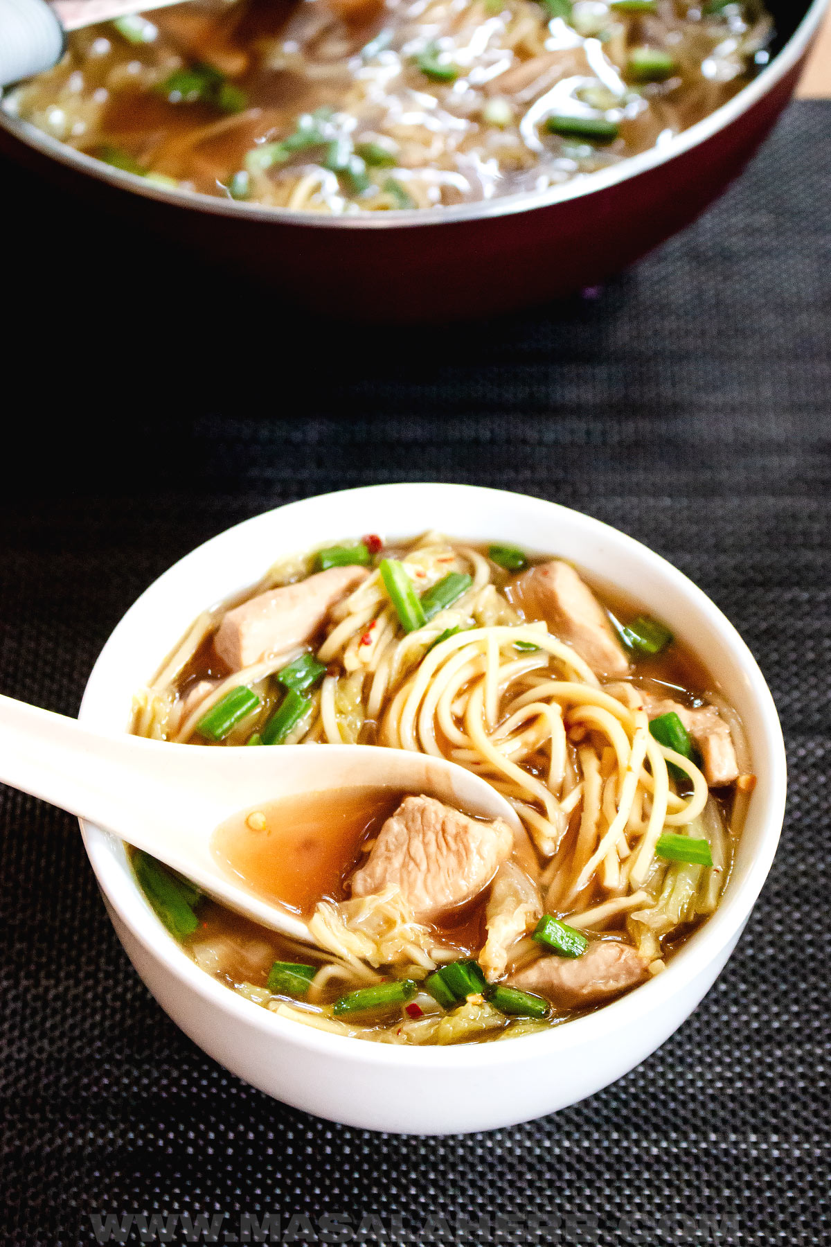a bowl of Chinese chicken noodle soup