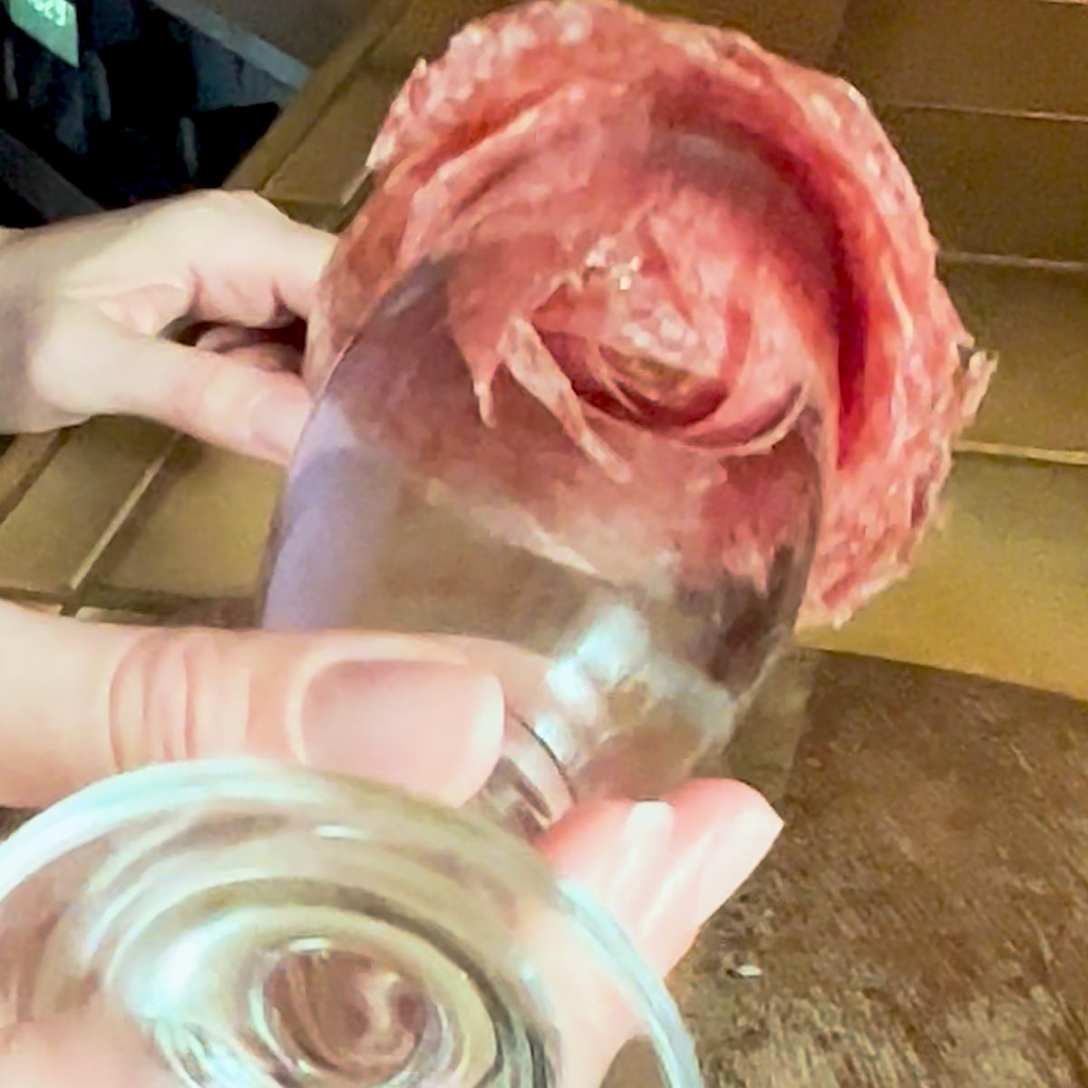 turning glass upside down to reveal the salami rose