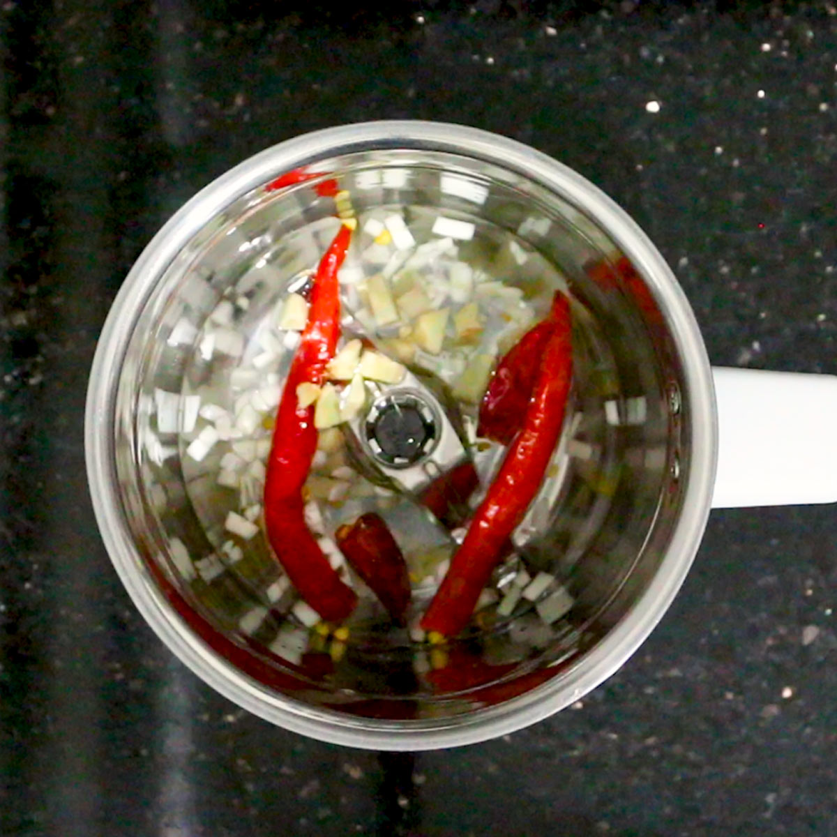 water added to ginger garlic chili in blender jar