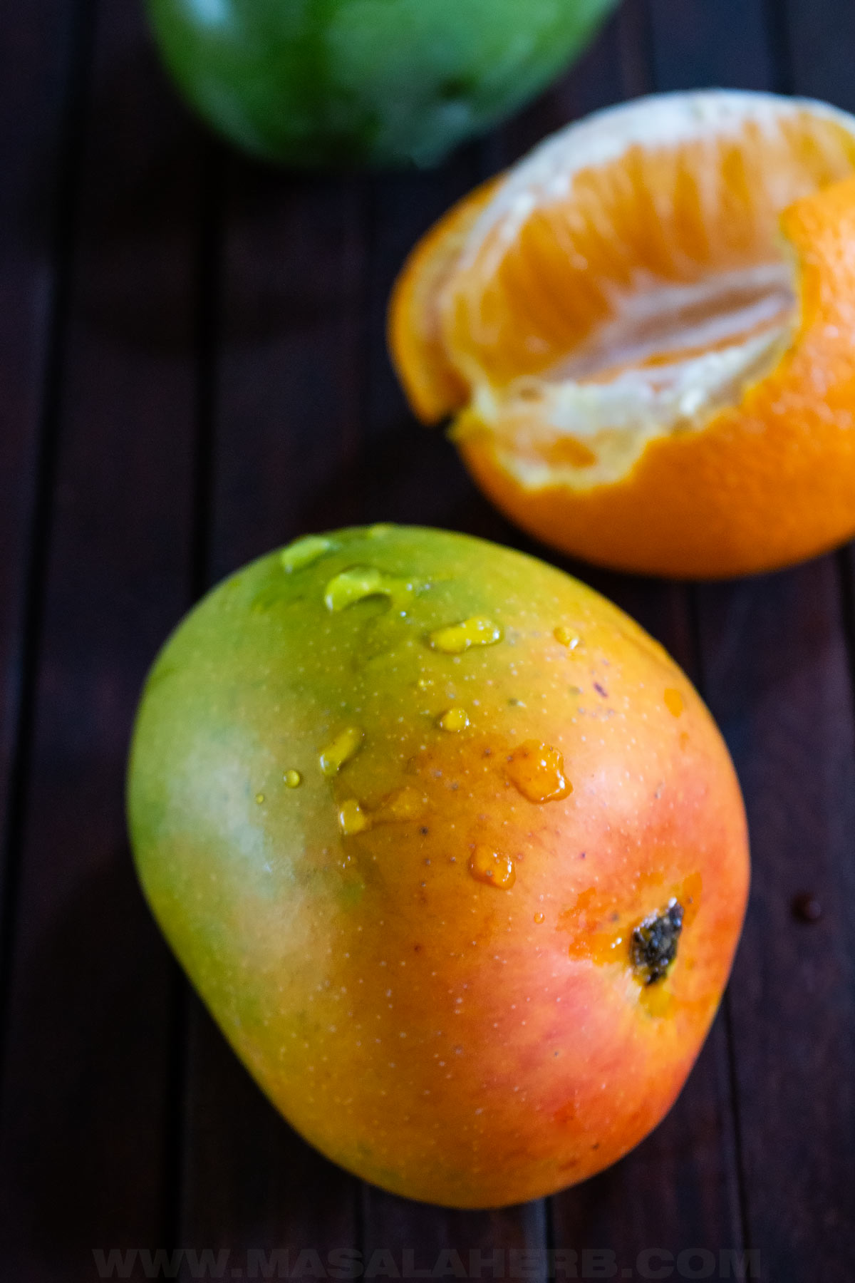 fresh mango with orange at the back