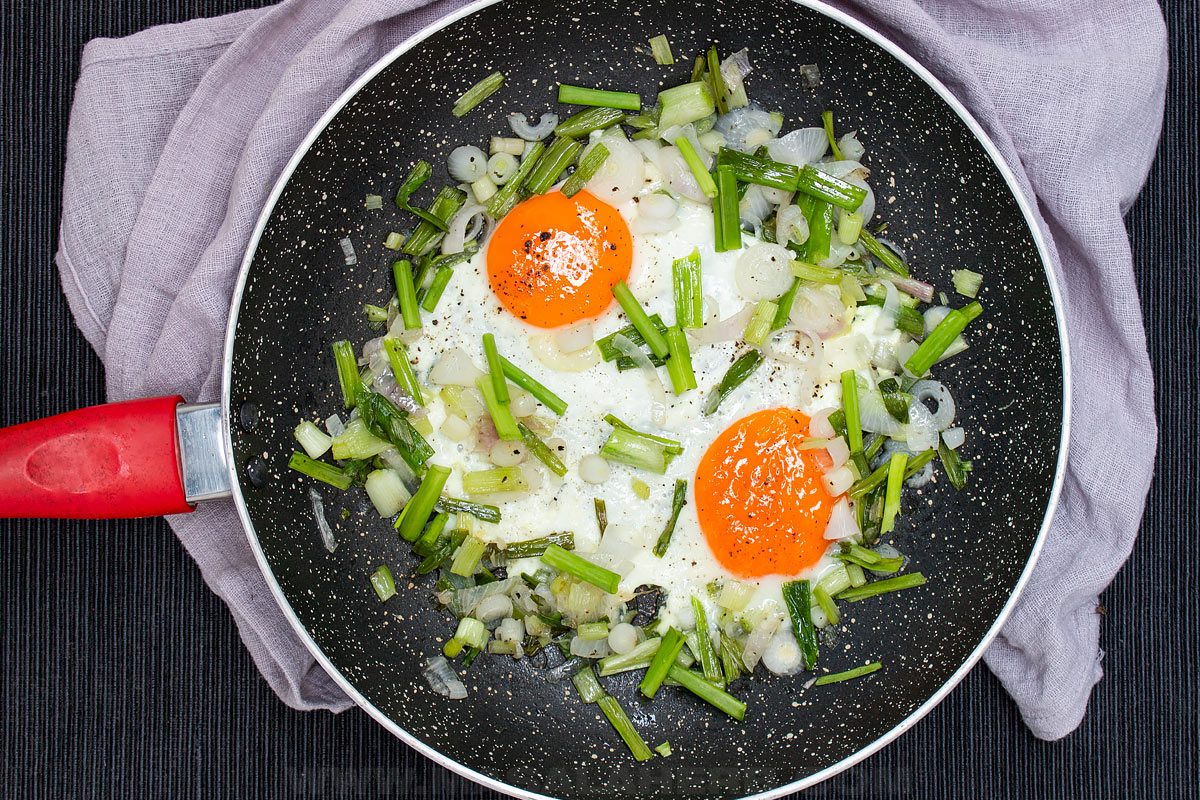 eggs and spring onions in a pan