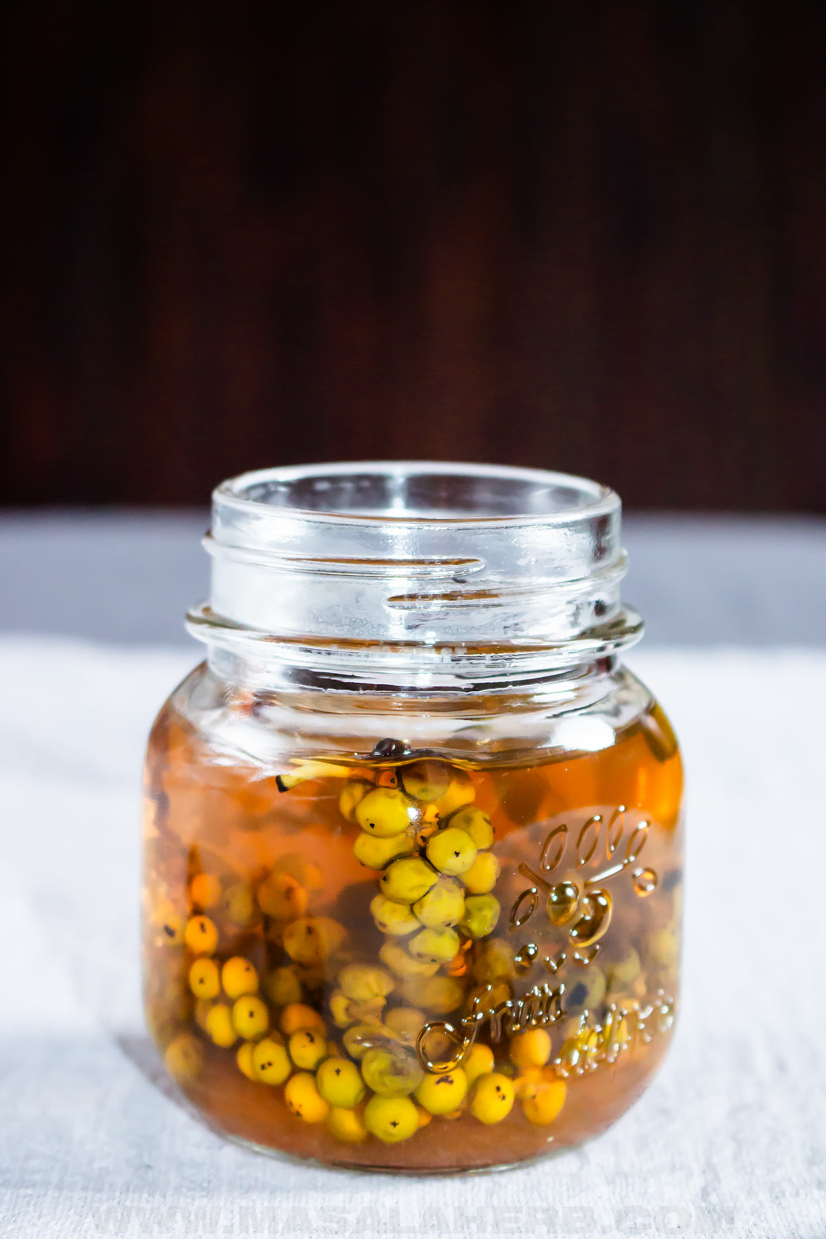 Green Peppercorns in a jar of brine