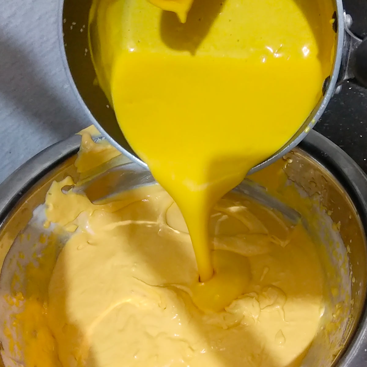 pour tempered gelatin filling mix to the rest of the mango cream cheese batter